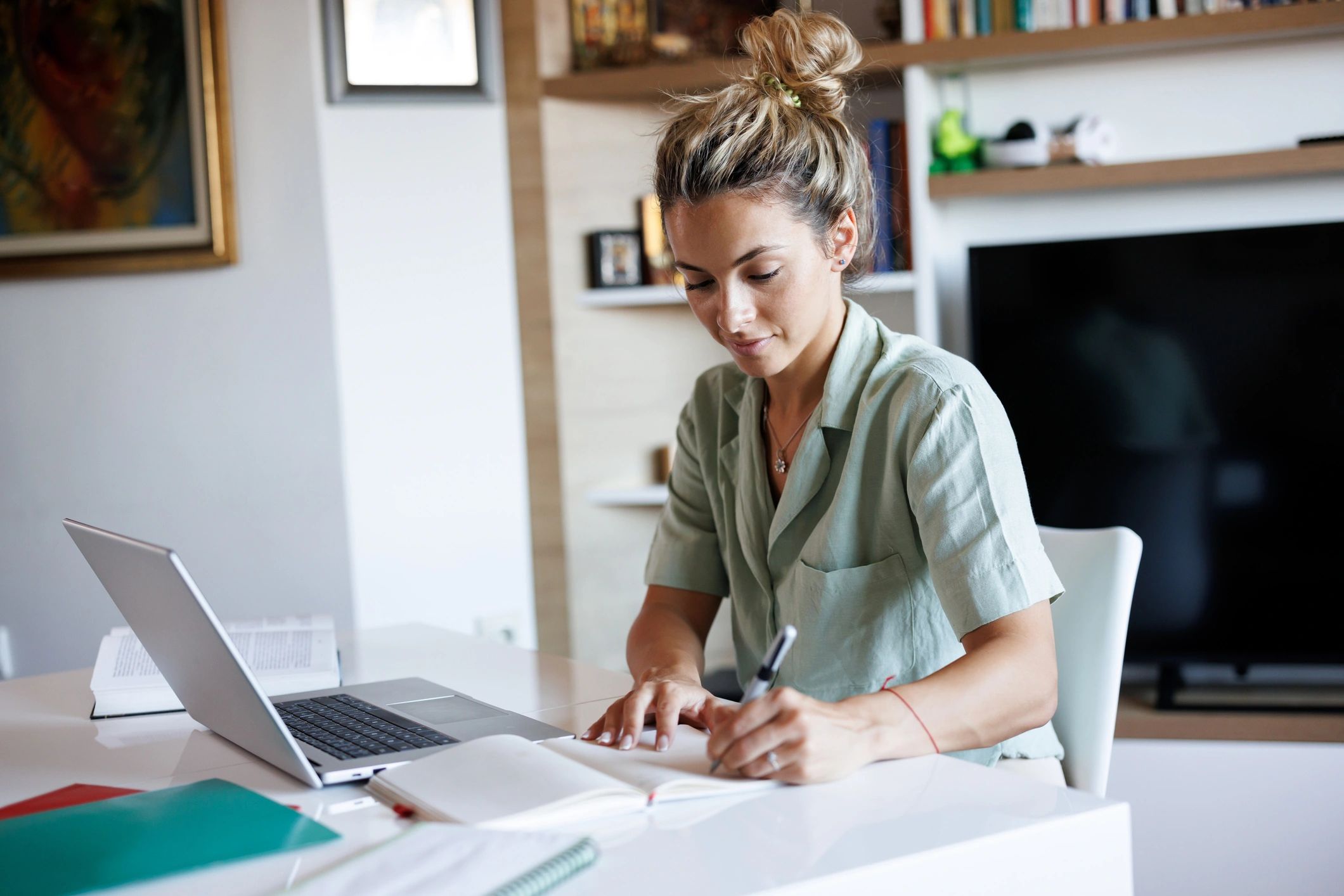 Student studying and taking notes at a desk