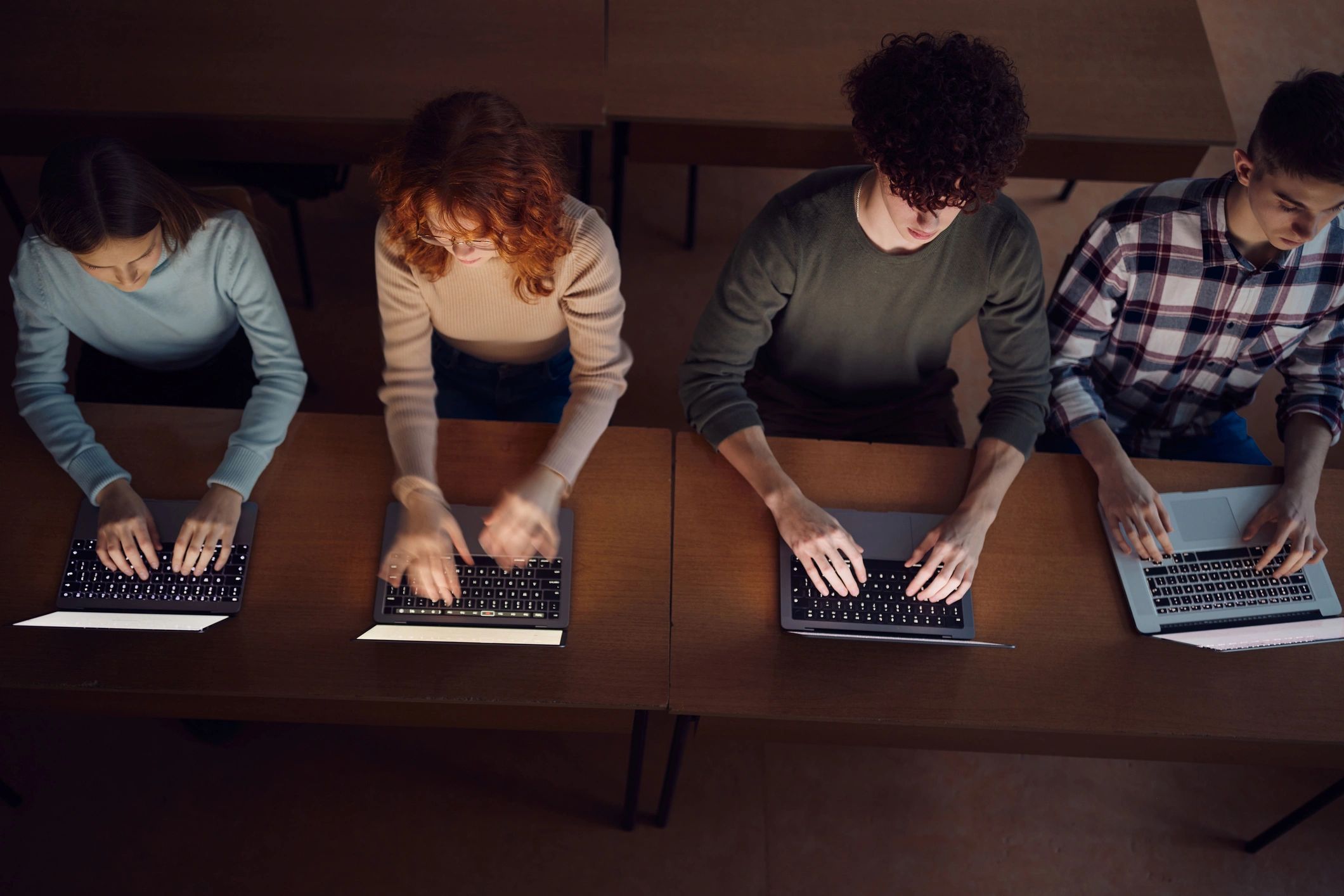Students studying together with laptops in a classroom
