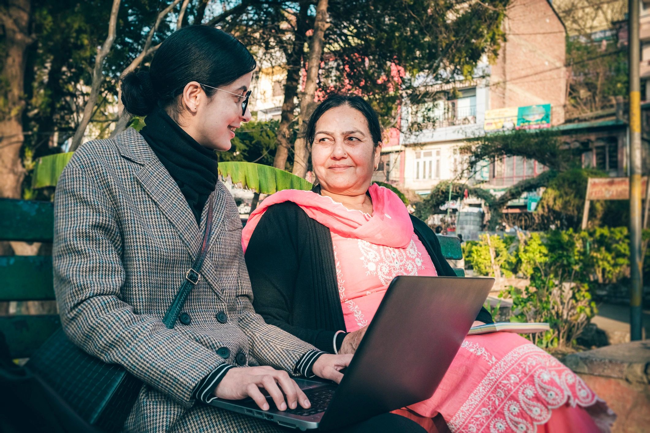 Mentor and learner working together with a laptop